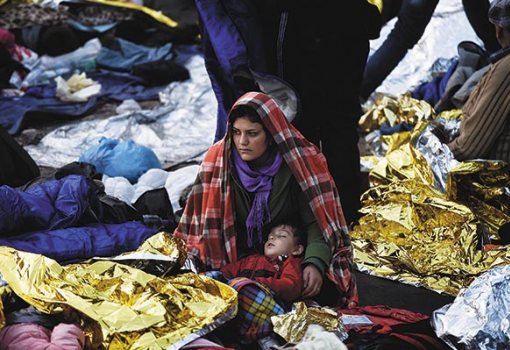 <h1>A kihűléstől óvja fiát egy anya Leszbosz partjainál. Görögországot is tehermentesítheti a menekülteket elosztó kvótarendszer, amely péntektől működésbe lépett - Fotó: Aris Messinis, AFP/Europress</h1>-
